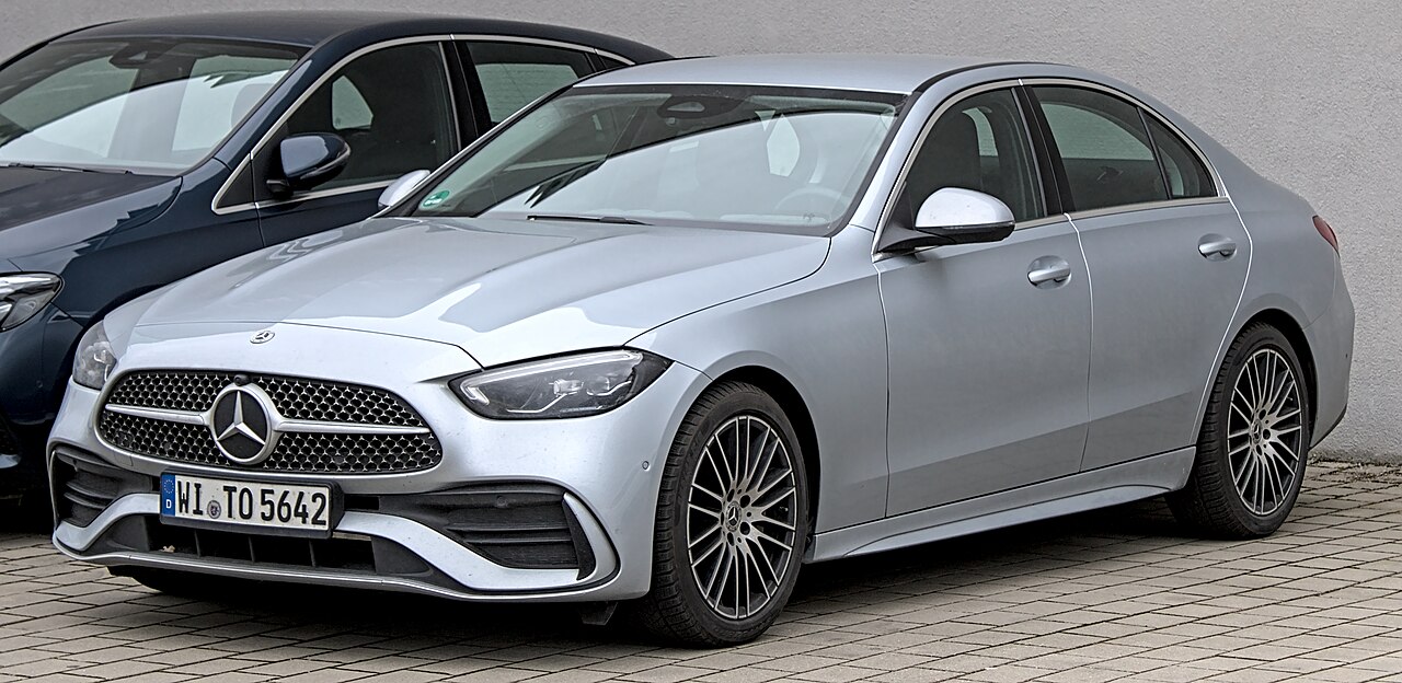 BMW 3 Series, Mercedes C-Class, and Audi A4 lined up on German Autobahn